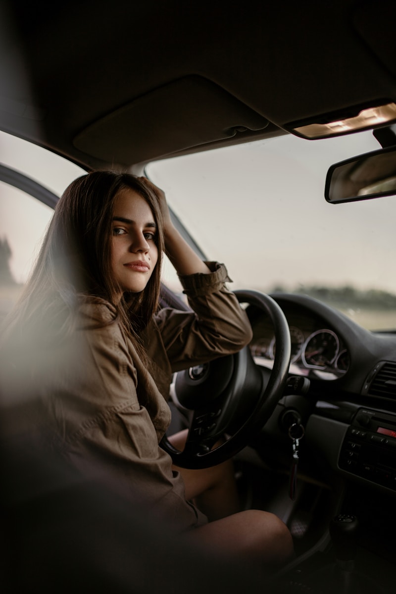 woman with underinsured motorist coverage sitting inside car